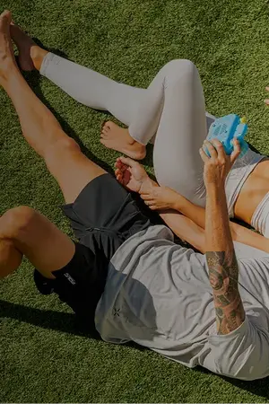 Couple enjoying themselves and taking a selfie on their new artificial grass installation specifically designed for terraces, balconies or attics.