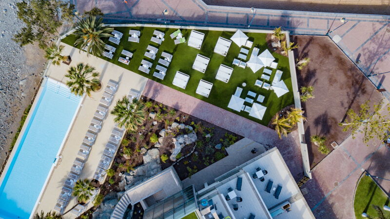 Hotel view of pool and grass 