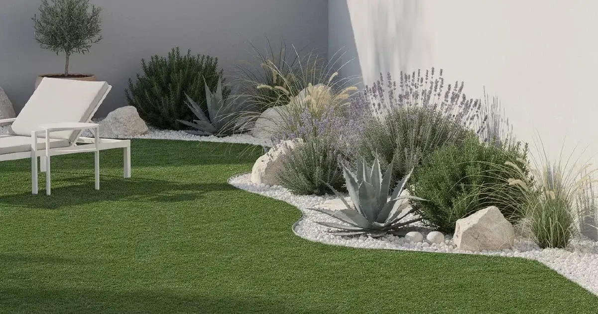 Modern outdoor garden with artificial grass lawn, white lounge chair, side table, and xeriscape planting beds with lavender, agave, and decorative rocks.