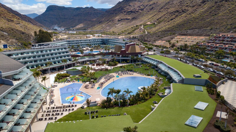 Hotel in the mountains with turfgrass along pool